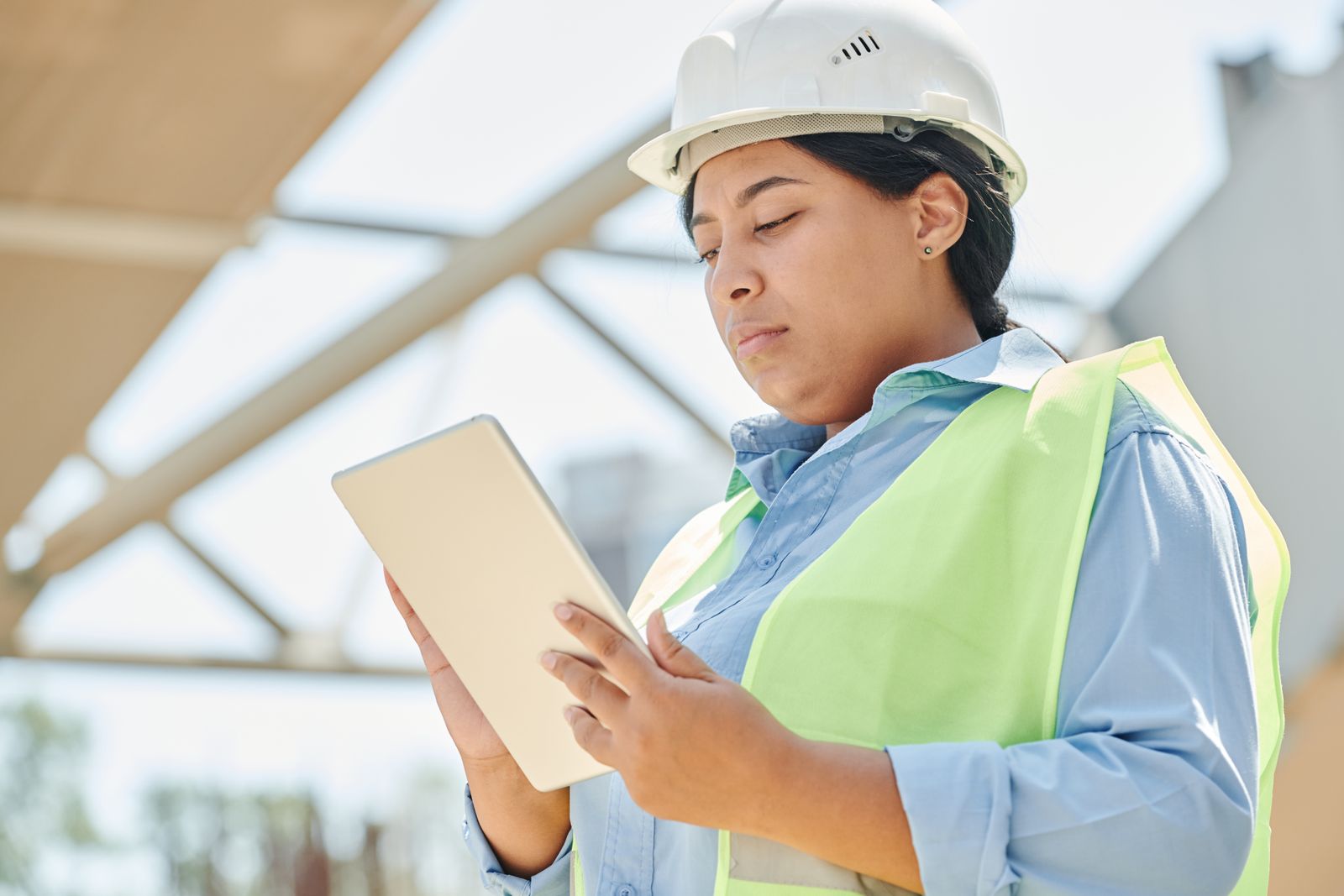 Field engineer reviewing project data on a tablet at a job site